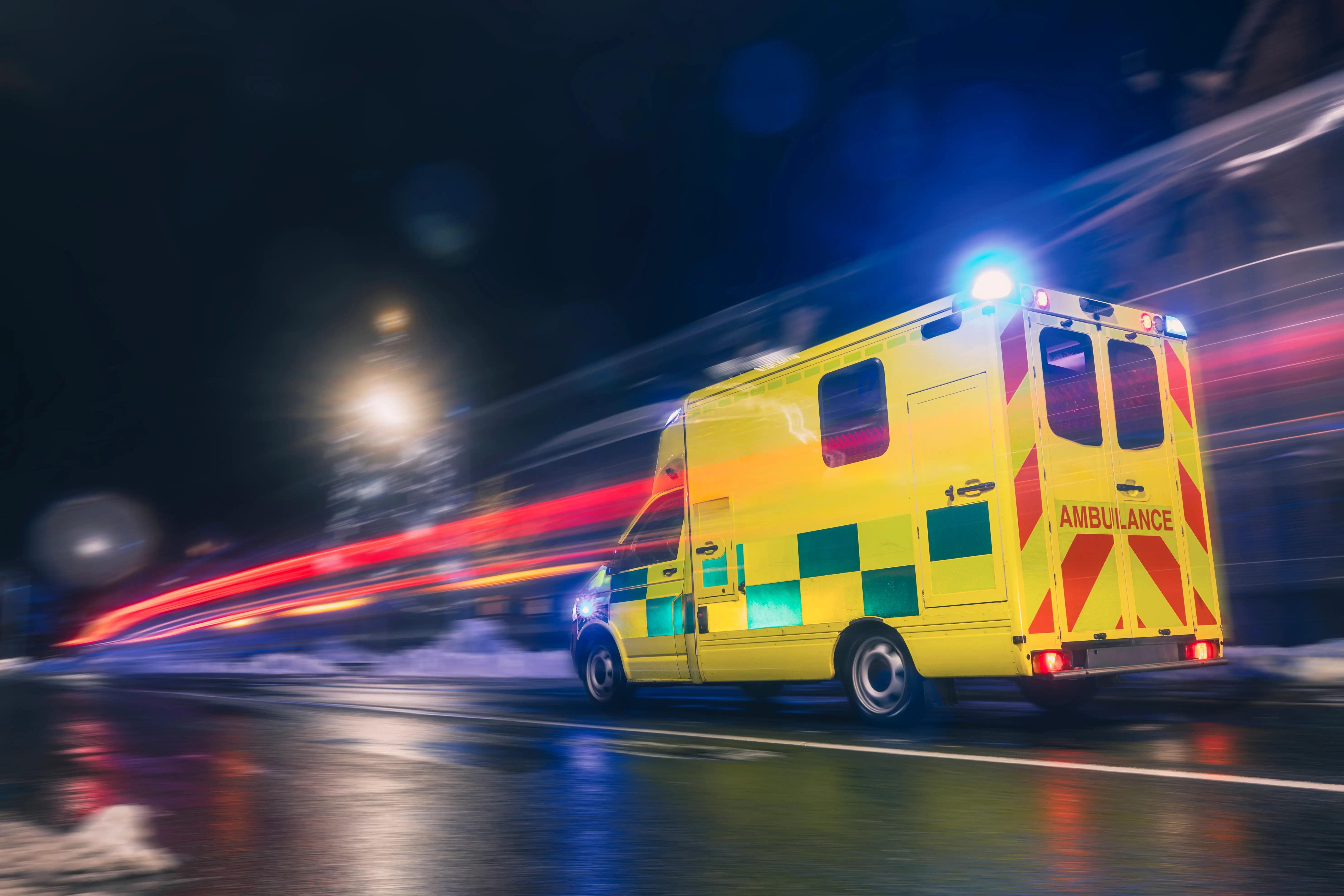 C1 ambulance training vehicle travelling through city streets at night