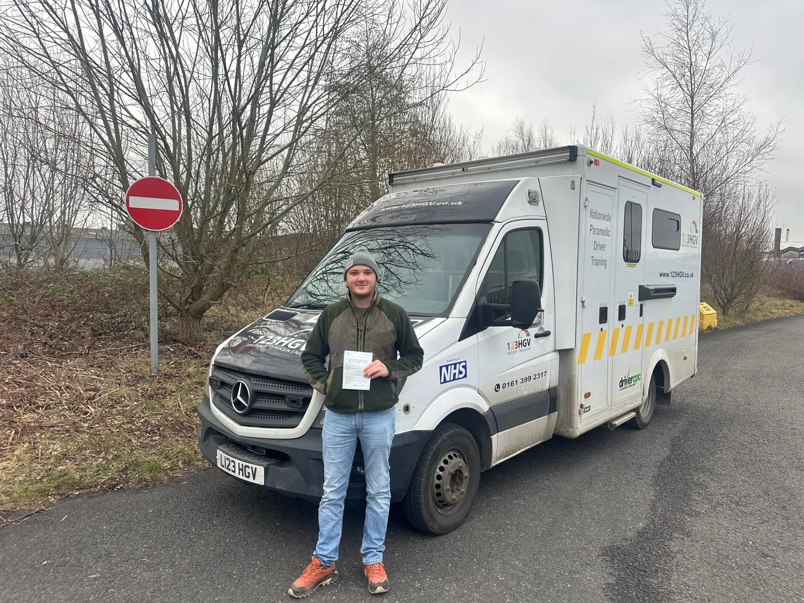 This could be you after your C1 training. C1 learner holding a pass certificate by the ambulance training vehicle