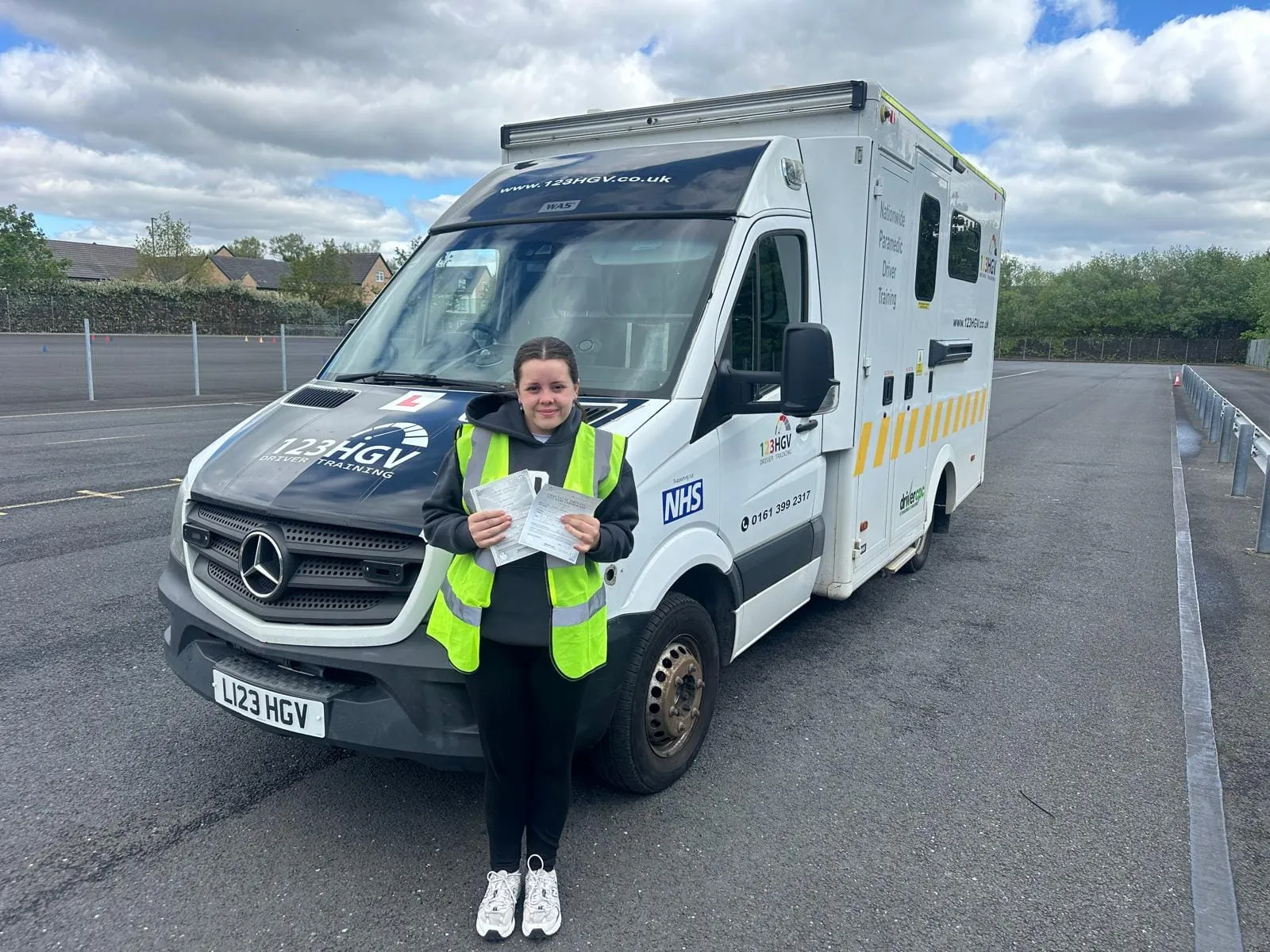 Passed learners, real vehicles and in-house training. C1 learner pass image beside branded ambulance training vehicle